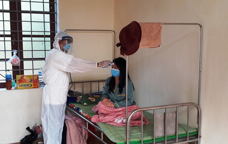 Nhân viên y tế kiểm tra thân nhiệt công dân tại khu cách ly y tế tập trung. Thanh Hóa truy vết F1, F2, xử lý nghiêm vi phạm phòng dịch -0