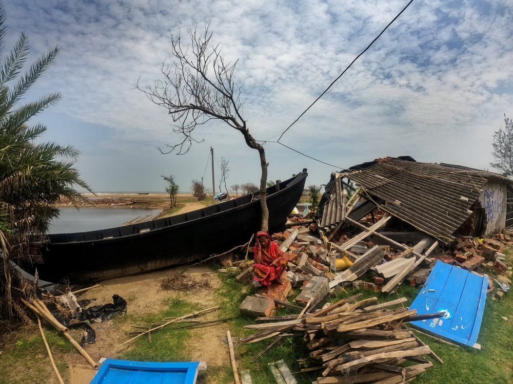 Người phụ nữ ngồi bên ngôi nhà tan hoang sau bão Yaas. Hình ảnh tại Kolkata, Ấn Độ. (Ảnh: Shutterstock) Climate crisis -0