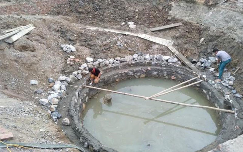 Giếng mới đang được xây trong lòng giếng cũ. (Ảnh: Báo Pháp luật) Trùng tu di sản: Bài học chưa bao giờ cũ -0