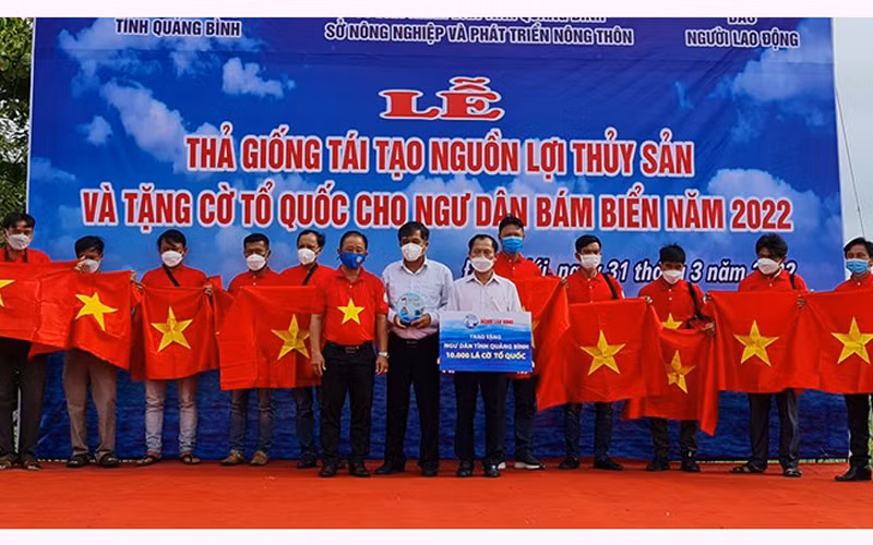Các đại biểu tặng cờ Tổ quốc cho ngư dân Quảng Bình.