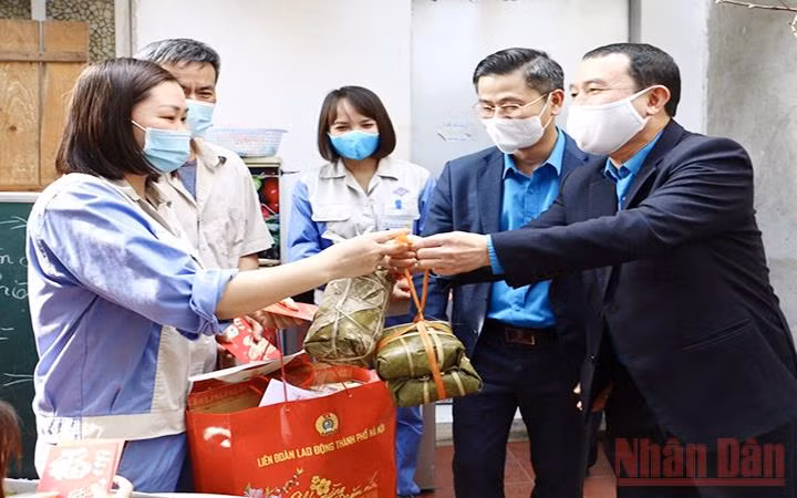 Đại diện Liên đoàn Lao động TP Hà Nội và Công đoàn các khu công nghiệp - chế xuất Hà Nội trao quà tặng công nhân lao động ở lại nhà trọ đón Tết Tân Sửu. (Ảnh: P. NGÂN)