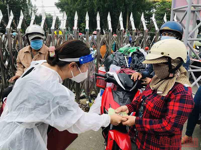 Chị Phan Thu Hiền phát tiền hỗ trợ người dân đổ xăng về quê. Mong anh, chị em công nhân sớm trở lại Đồng Nai -0