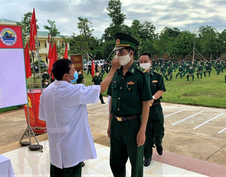 Tất cả cán bộ, chiến sĩ vào khu vực bầu cử đều được đo thân nhiệt để phòng, chống dịch Covid-19. Rộn ràng ngày bầu cử sớm ở Đắk Lắk -0
