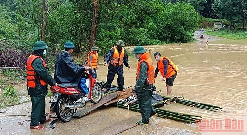 Đồn Biên phòng Phúc Sơn, BĐBP Nghệ An giúp người dân đi lại tại những điểm ngập sâu. (Ảnh: HẢI THƯỢNG) Mưa lớn khiến nhiều tuyến đường ở Nghệ An, Hà Tĩnh bị chia cắt -0