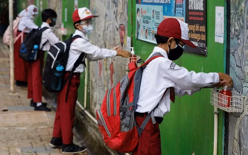 Học sinh tiểu học sát khuẩn tay sau khi tan học ở Jakarta, Indonesia, ngày 30/8/2021. (Ảnh minh họa: Reuters)