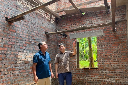 Cán bộ xã Yên Phúc, tỉnh Lạng Sơn (áo kẻ) đến thăm gia đình bà Nông Thị Việt (vợ liệt sĩ) đang được hỗ trợ xây mới nhà ở. 