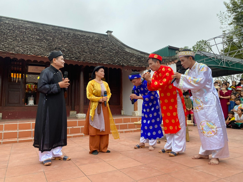 Người dân làng Quỳnh tái hiện câu chuyện “Ông đồ Nghệ và con cá gỗ”.