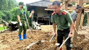 Cán bộ, chiến sĩ Công an Thái Nguyên hỗ trợ người dân địa phương xây dựng nhà mới. (Ảnh: Bộ Công an)