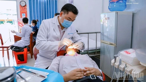 Bác sĩ chuyên khoa II Phạm Kim Thành khám bệnh cho học sinh trường nuôi dạy trẻ khuyết tật tỉnh Đồng Tháp.