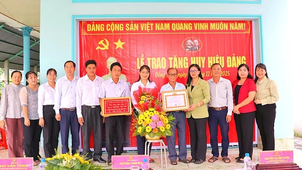 Trưởng Ban Tuyên giáo và Dân vận Tỉnh ủy Đồng Tháp Nguyễn Thị Kim Tuyến (Đứng thứ 4 từ phải sang) cùng đại diện cấp ủy xã Mỹ Thọ chụp hình lưu niệm cùng đảng viên Huỳnh Văn Bé tại lễ trao Huy hiệu Đảng.
