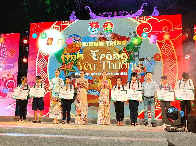 Đại biểu tham dự trao sổ tiết kiệm cho thiếu nhi bị ảnh hưởng bởi dịch bệnh Covid-19 (Ảnh: HỮU NGHĨA)