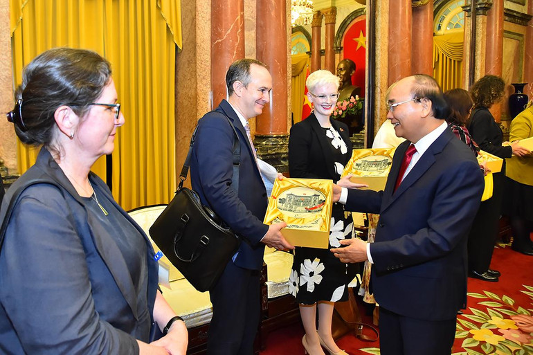 Chủ tịch nước Nguyễn Xuân Phúc trao quà tặng các thành viên trong đoàn tháp tùng Thủ tướng New Zealand Jacinda Ardern.