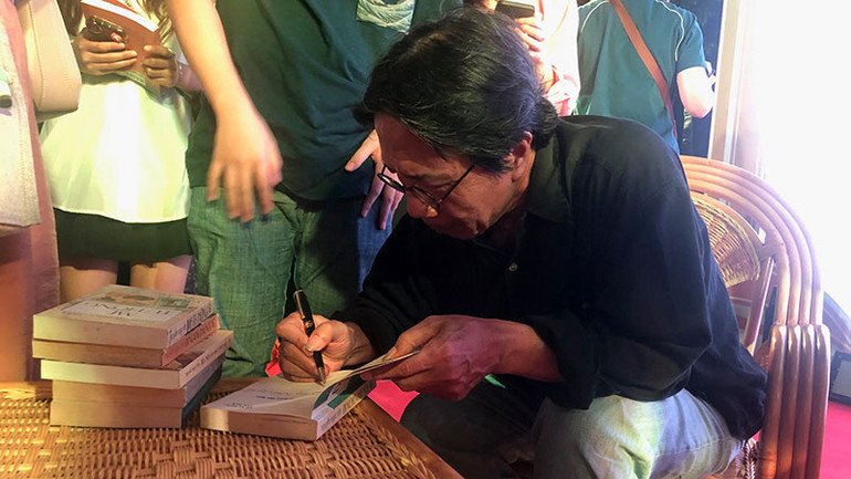 Nhà văn Nguyễn Ngọc Tiến ký sách cho bạn đọc. Nhà văn Nguyễn Ngọc Tiến ký sách cho bạn đọc.