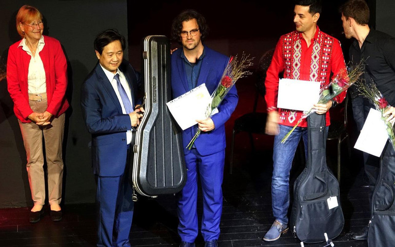 Giáo sư, nghệ sĩ Đặng Ngọc Long trao phần thưởng cho các thí sinh tham gia trong đêm Liên hoan Guitar quốc tế tại Berlin. Giáo sư, nghệ sĩ Đặng Ngọc Long trao phần thưởng cho các thí sinh tham gia trong đêm Liên hoan Guitar quốc tế tại Berlin.