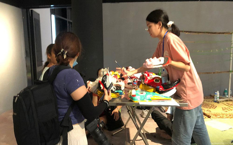 Khách nước ngoài mua mặt nạ truyền thống Việt Nam.