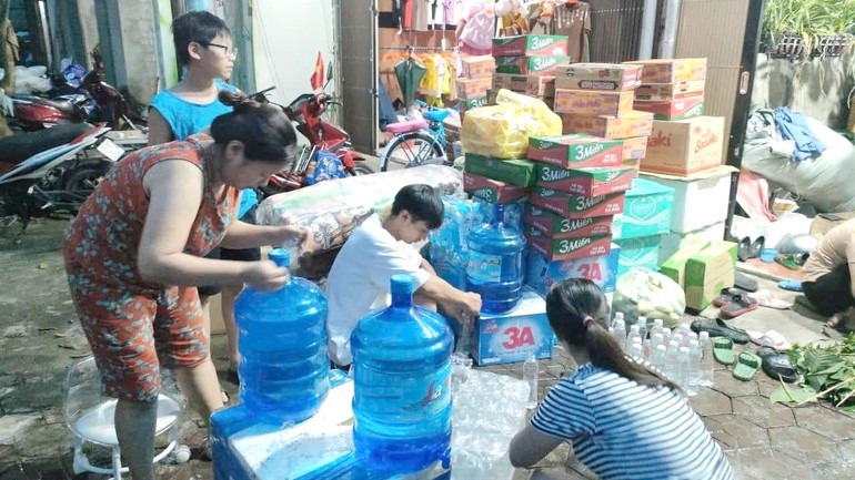 Một hộ gia đình ở thị trấn Tam Đường chuẩn bị nước lọc để gửi sang vùng lũ Lào Cai.