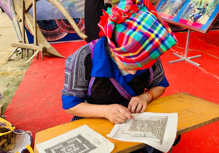 Phụ nữ H'Mông Mù Cang Chải vẽ sáp ong trên vải. (Ảnh THANH SƠN)