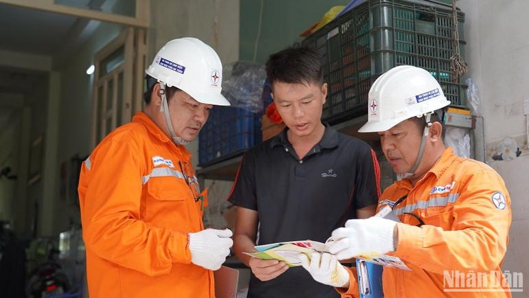 Công nhân EVNHCMC tuyên truyền sử dụng điện an toàn cho người dân