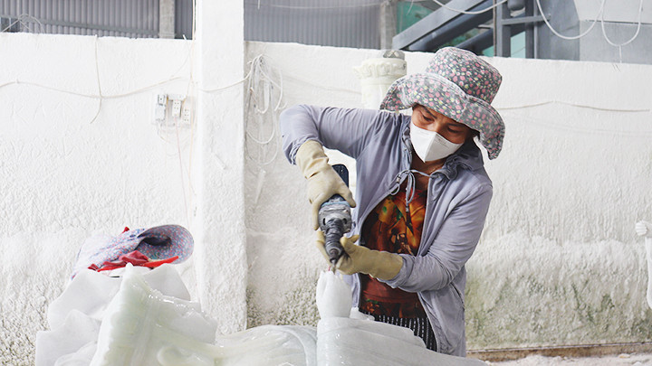 Chị Bình chạm khắc tượng.