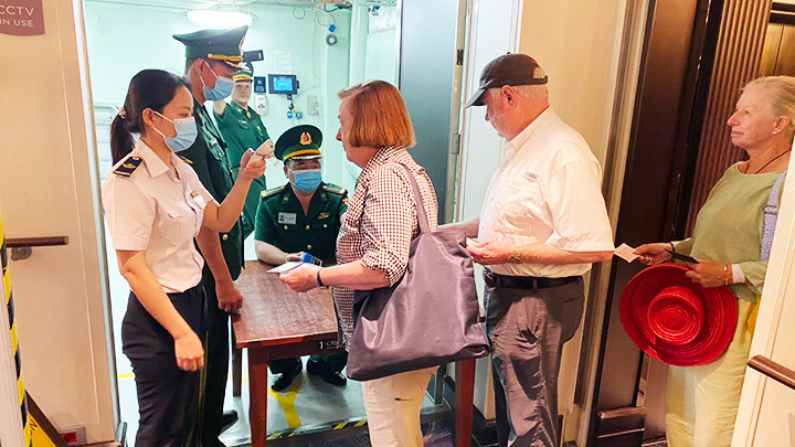 Cán bộ kiểm dịch y tế đo thân nhiệt du khách trên tàu. Cán bộ kiểm dịch y tế đo thân nhiệt du khách trên tàu.