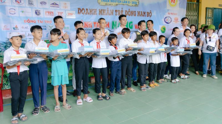 Tặng quà cho học sinh khó khăn tại Chương trình Caravan Doanh nhân trẻ Nam Bộ năm 2023.