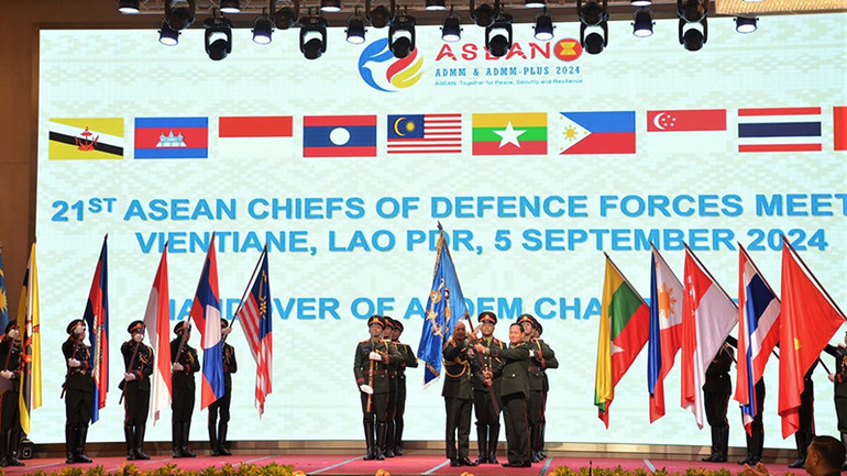 Tổng Tham mưu trưởng Quân đội nhân dân Lào trao cờ đăng cai cho đại diện Malaysia. (Ảnh: Hải Tiến) Tổng Tham mưu trưởng Quân đội nhân dân Lào trao cờ đăng cai cho đại diện Malaysia. (Ảnh: Hải Tiến)