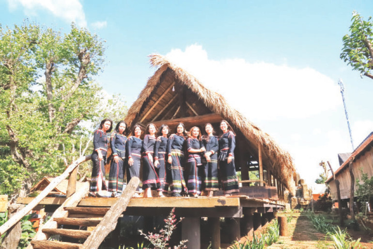 Những cô gái Ê Đê duyên dáng bên nhà sàn dài truyền thống.