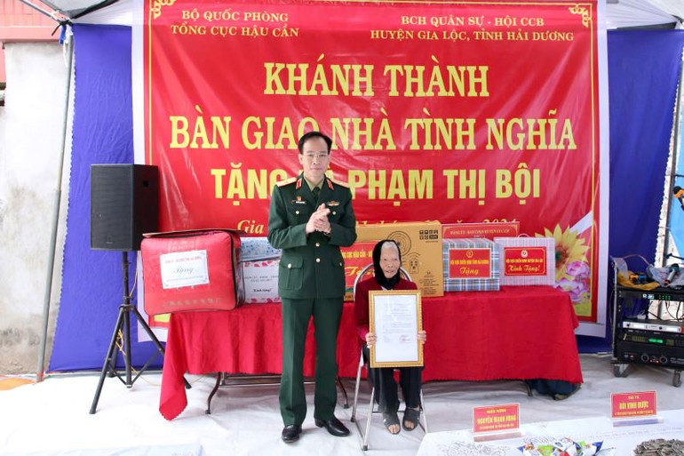 Thiếu tướng Nguyễn Mạnh Hùng, thừa ủy quyền của Thủ trưởng Tổng cục Hậu cần trao Quyết định hỗ trợ kinh phí và quà tặng gia đình bà Phạm Thị Bội.