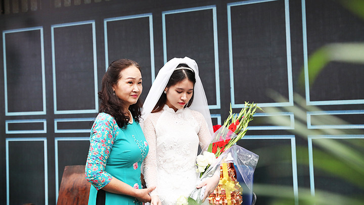 Bà mối dẫn cô dâu ra chào nhà trai.