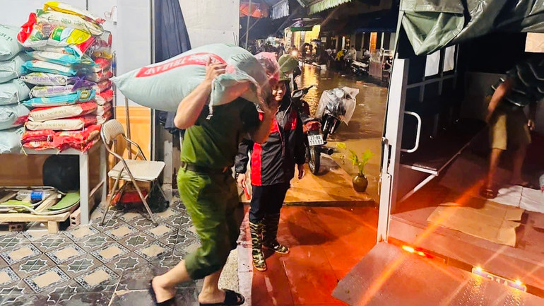 Giúp dân chạy lũ. (Ảnh: THANH SƠN)