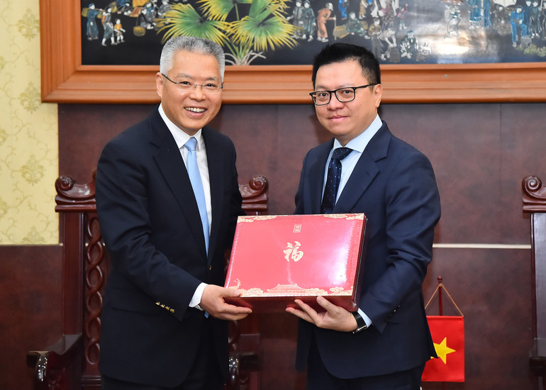 Đồng chí Hồ Triệu Minh trao quà lưu niệm tặng đồng chí Lê Quốc Minh.