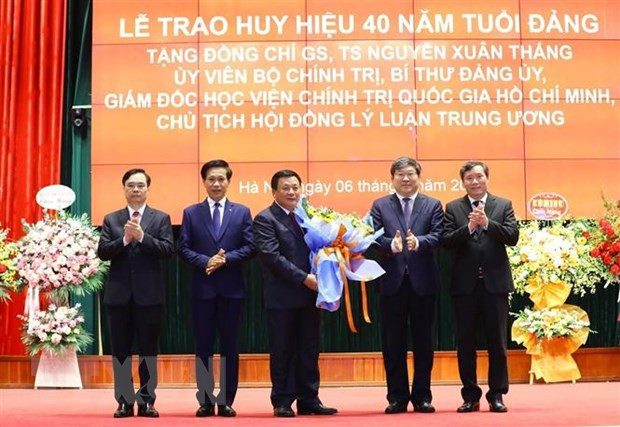 Thường trực Đảng ủy Học viện Chính trị Quốc gia Hồ Chí Minh tặng hoa chúc mừng đồng chí Nguyễn Xuân Thắng. (Ảnh: Văn Điệp/TTXVN)