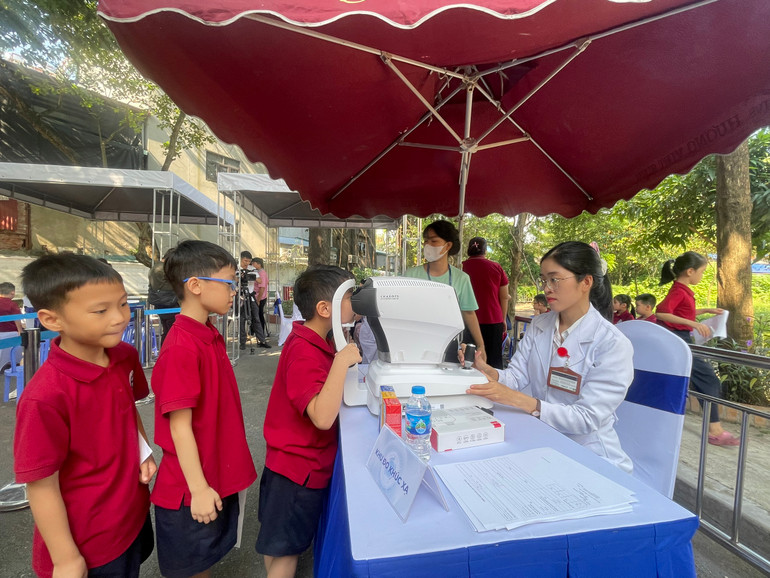 Các bác sĩ khám sàng lọc cho các em nhỏ.