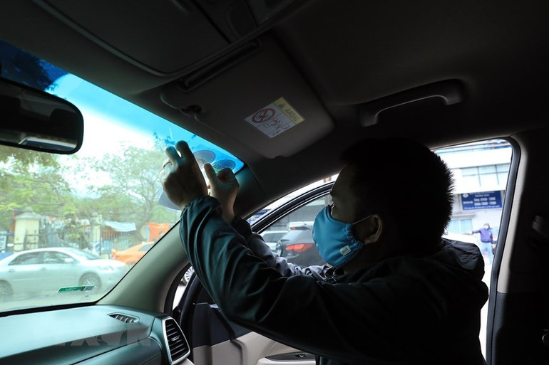 Cán bộ kỹ thuật Trung tâm đăng kiểm xe cơ giới số 29.03V dán tem đăng kiểm đối với các xe đã kiểm tra.