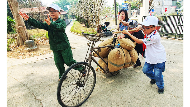 Học sinh “thử” làm dân công thồ gạo tại di tích lịch sử đồi A1.