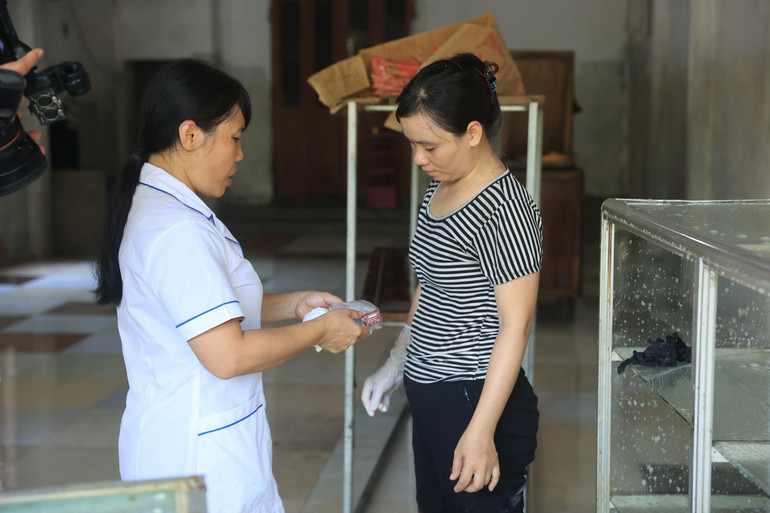 Cấp phát thuốc phòng bệnh cho người dân vùng chịu ảnh hưởng của ngập lụt.