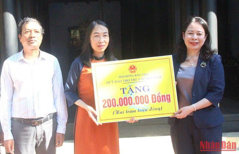 Phó Chủ tịch nước Võ Thị Ánh Xuân trao biểu trưng hỗ trợ 200 triệu đồng cho lãnh đạo Sở Lao động-Thương binh và Xã hội để tặng quà, hỗ trợ trẻ em hoàn cảnh khó khăn.