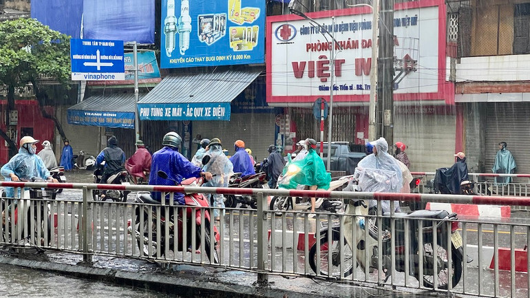 Nhiều người dừng lại trên cầu Đò Quan khi lo ngại không thể vượt qua các tuyến đường ngập sâu trong thành phố.