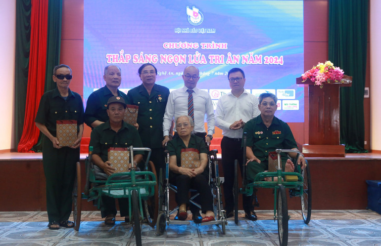 Đồng chí Lê Quốc Minh (đứng ngoài cùng bên phải) cùng nhà tài trợ tặng quà cho các thương binh, bệnh binh.