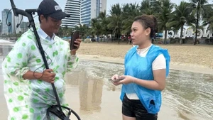 Nữ du khách nhận lại tài sản bị sóng biển nhấn chìm sau nỗ lực hỗ trợ, tìm kiếm của các nhân viên Ban Quản lý bán đảo Sơn Trà và các bãi biển du lịch Đà Nẵng. (Ảnh: HG)