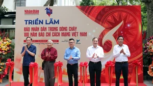 Đồng chí Lê Quốc Minh, Ủy viên Trung ương Đảng, Tổng Biên tập Báo Nhân Dân, Phó Trưởng ban Tuyên giáo và Dân vận Trung ương, Chủ tịch Hội Nhà báo Việt Nam (đứng chính giữa), đồng chí Hoàng Trung Dũng, Ủy viên Ban Chấp hành Trung ương Đảng, Tổng Biên tập Tạp chí Cộng sản (thứ hai, từ phải sang) cùng các đồng chí nguyên Tổng Biên tập Báo Nhân Dân cắt băng khai mạc Triển lãm. (Ảnh KHIẾU MINH)
