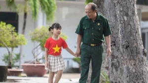 Thượng sĩ Nguyễn Chí Tường cùng con một nhân viên Vinamilk tại Trung tâm Điều dưỡng Thương binh và Người có công Long Đất. (Ảnh: THANH BÌNH)