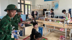 Chiến sĩ Đồn Biên phòng Roòn, tỉnh Quảng Trị, cung cấp nước uống cho người dân tại nơi sơ tán.