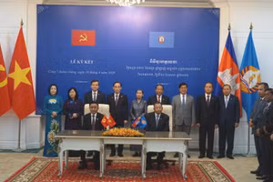 Thường trực Ban Bí thư Trần Cẩm Tú và Phó Chủ tịch Đảng Nhân dân Campuchia, Trưởng Ban Thường trực Ban Thường vụ Đảng Nhân dân Campuchia Say Chhum chứng kiến lễ trao các văn kiện hợp tác. (Ảnh: ĐINH TRƯỜNG) 
