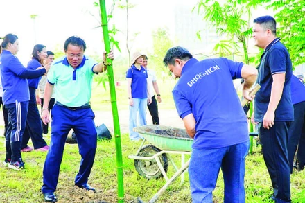 Ông Tăng Hữu Thủy, Bí thư Đảng ủy, Giám đốc Trung tâm Quản lý Ký túc xá và Khu đô thị Đại học Quốc gia Thành phố Hồ Chí Minh cùng cán bộ, giảng viên, sinh viên tham gia trồng tre.