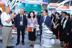 Các đại biểu và khách tham quan một gian hàng tại triển lãm.