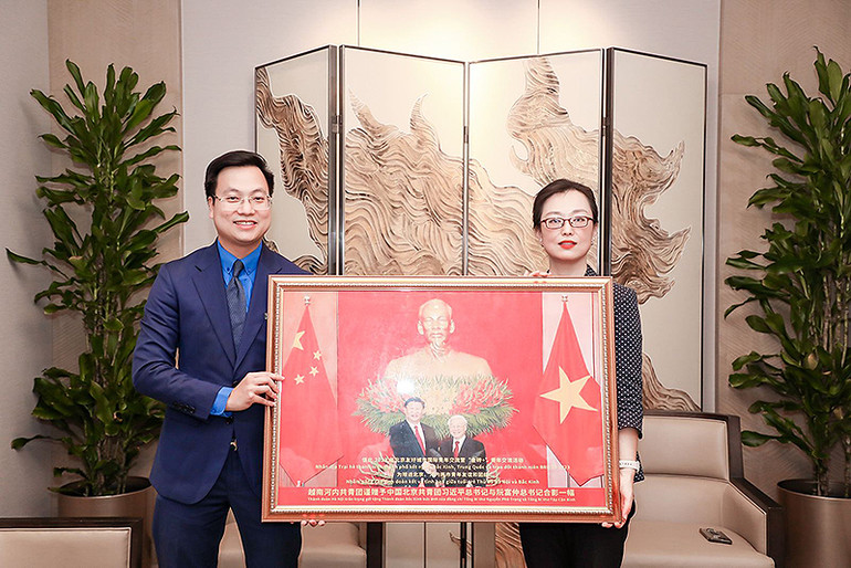 Phó Bí thư Thành đoàn Hà Nội trao bức tranh Tổng Bí thư Nguyễn Phú Trọng và Chủ tịch Trung Quốc Tập Cận Bình tặng Phó Bí thư Thành đoàn Bắc Kinh Qiao Xuehui tại buổi làm việc.