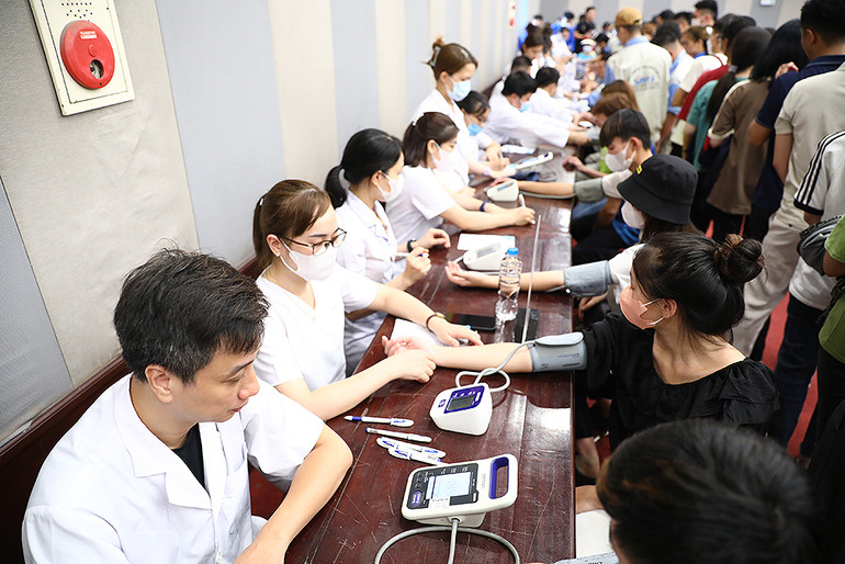 Các y, bác sĩ tình nguyện của Hội Thầy thuốc trẻ Việt Nam khám bệnh cho thanh niên công nhân tại Ngày hội.