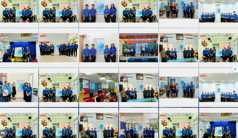Các bạn trẻ treo bản đồ Tổ quốc tại không gian học tập, làm việc.