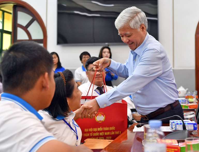 Đồng chí Đỗ Văn Chiến trao quà tặng các đại biểu tại buổi gặp mặt. Trong ảnh là chị Nguyễn Thùy Chi, Nhà đồng sáng lập, Phó Giám đốc Công ty TNHH "Chạm vào Xanh".